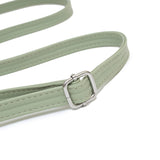 綠色彷皮飾帶細節金屬圓釘護角雙拉鍊隔層手提斜背包